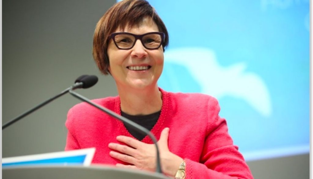 Photo of Dr. Cindy Blackstock delivering speech after receiving the Law Society's Human Rights Award in March 2017. She is at a podium with a microphone. She is smiling and her hand is on her chest.