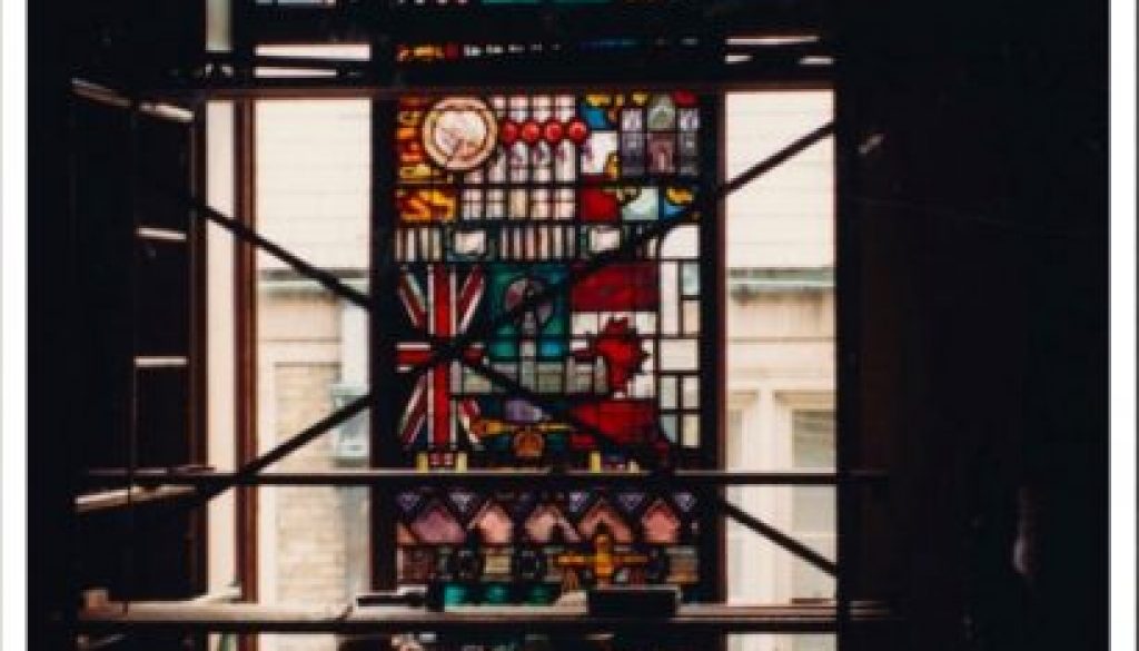 Picture of a large stained-glass window being created at Osgoode Hall. Gazette article title is "Christopher Wallis: Law in light and glass" (Writer; 2013)